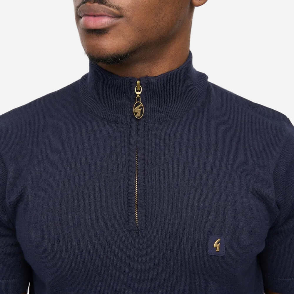 Close-up of a man wearing a Gabicci LASSO Quarter Zip Polo in navy, showcasing the zip and collar design.