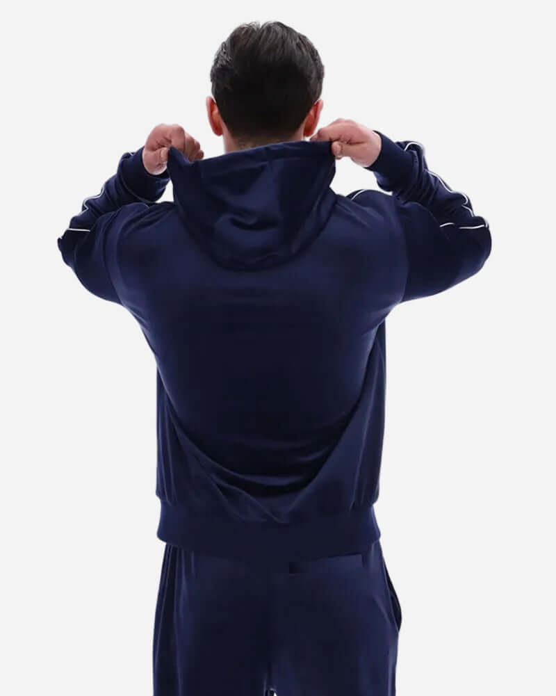 Back view of a man wearing a Fila Vintage ITALO Velour Hoodie Navy, showcasing the luxurious velour fabric and hood.