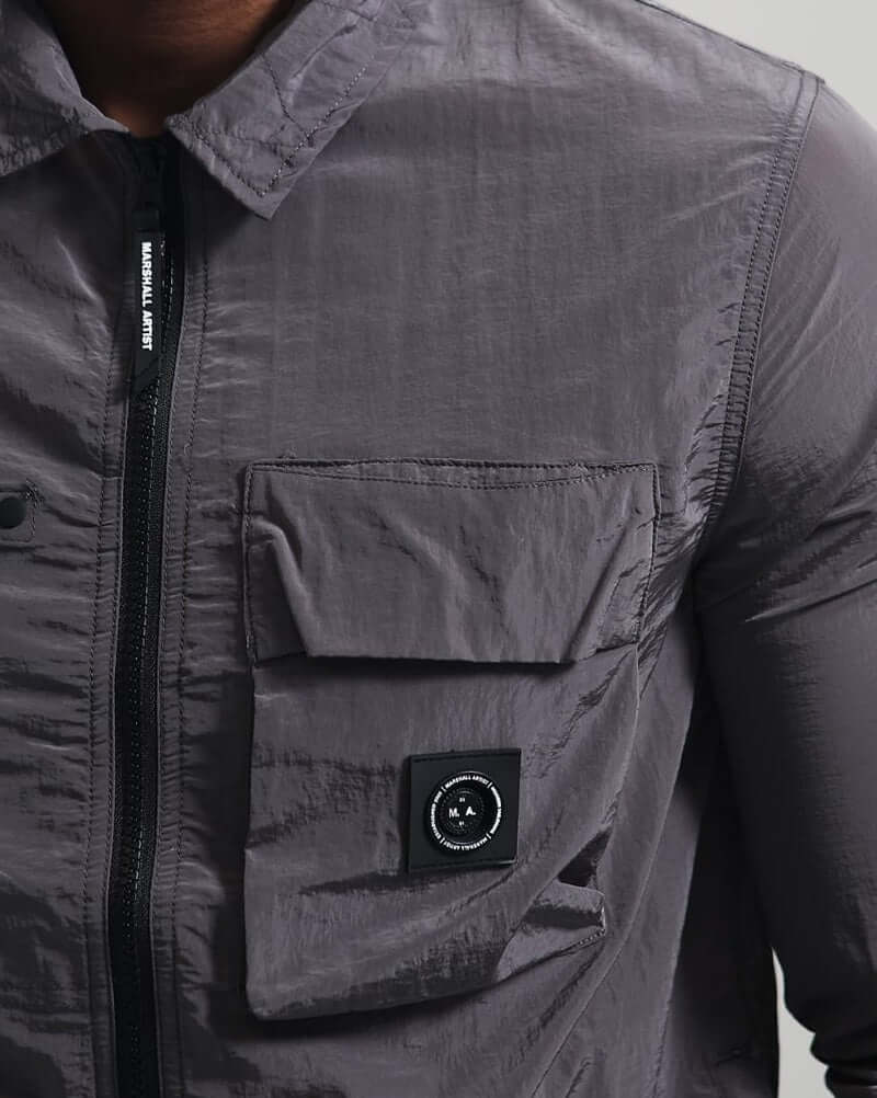 Close-up of Marshall Artist CARICO Overshirt in Volcanic Grey showcasing its fabric, zip fastening, and logo detail.