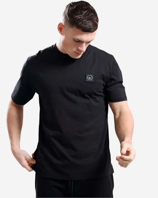 Model wearing Marshall Artist SIREN T Shirt in black, featuring crew neck and micro siren branding.