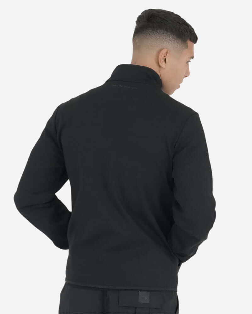 Man wearing the Peaceful Hooligan CONQUEST Jacket Black, showcasing the back design and collar detail.