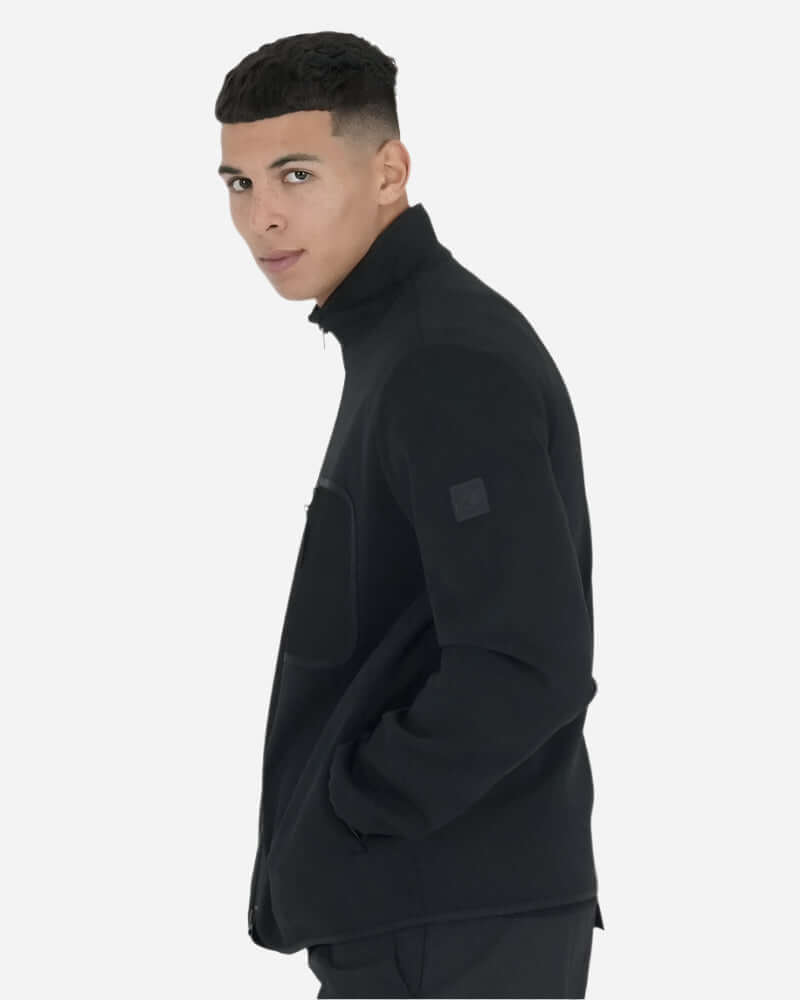 Peaceful Hooligan CONQUEST Jacket Black worn by a model, featuring a stylish design and functional pockets.