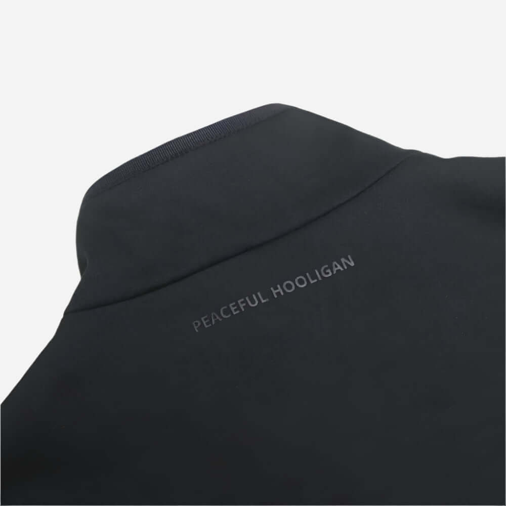 Close-up of the Peaceful Hooligan CONQUEST Jacket Black showcasing the logo on the back neck.