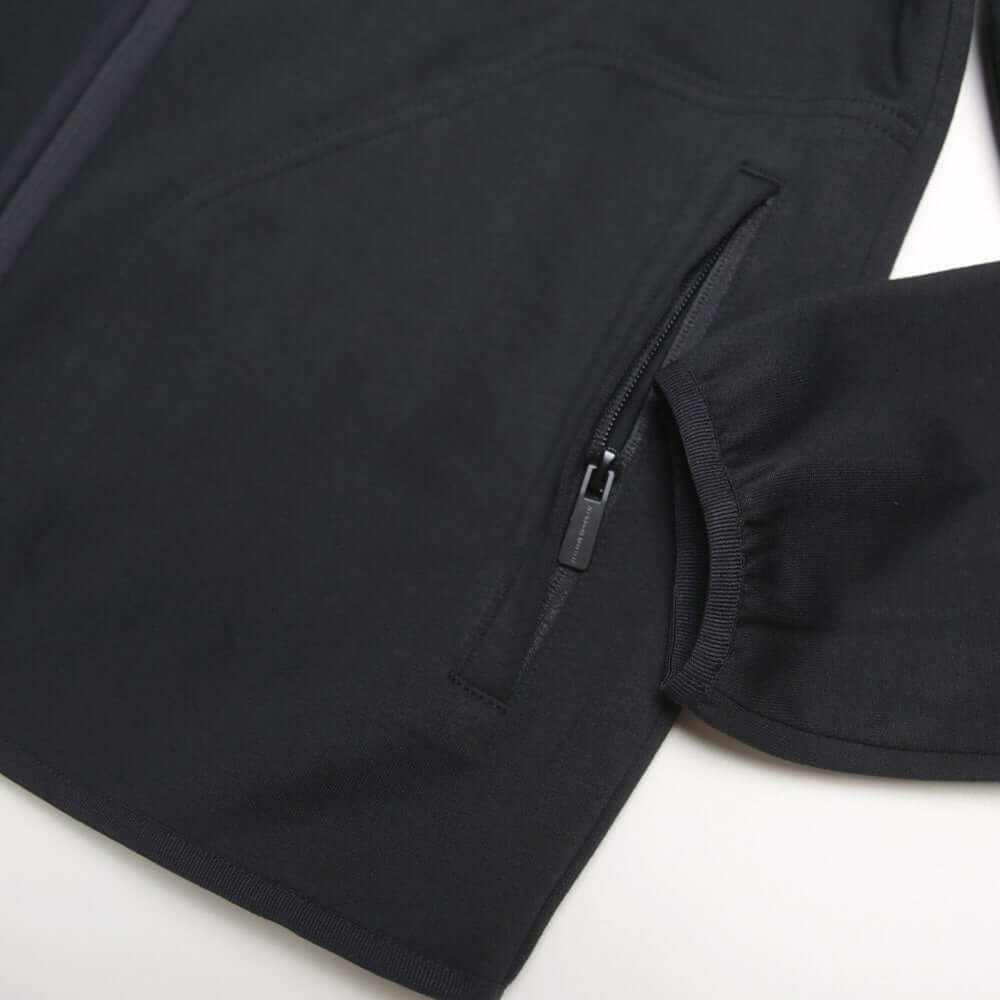 Close-up of the Peaceful Hooligan CONQUEST Jacket Black showing the zipper pocket and sleeve details.