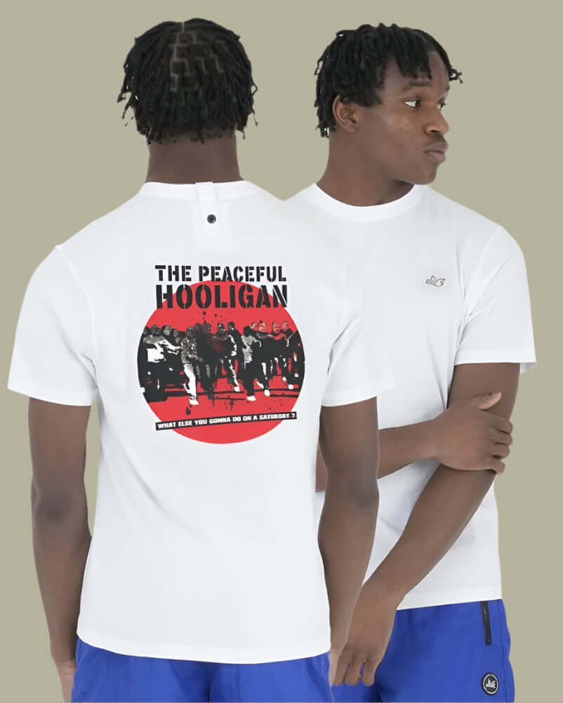 Model wearing the white Peaceful Hooligan THE FOOTY FACTORY T-shirt with iconic back print and dove logo.