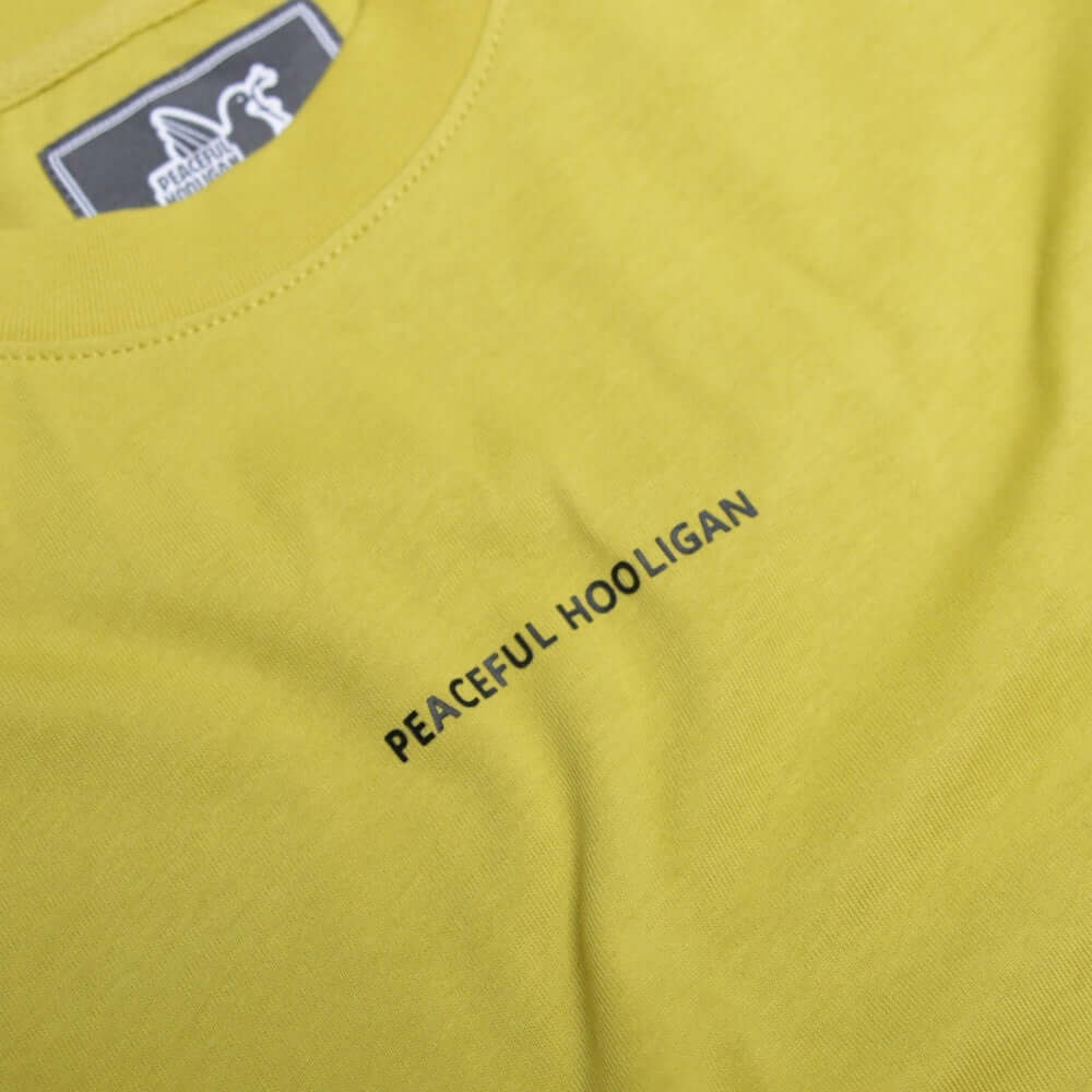 Peaceful Hooligan Acid Mustard T-Shirt featuring black print on a vibrant mustard yellow background.