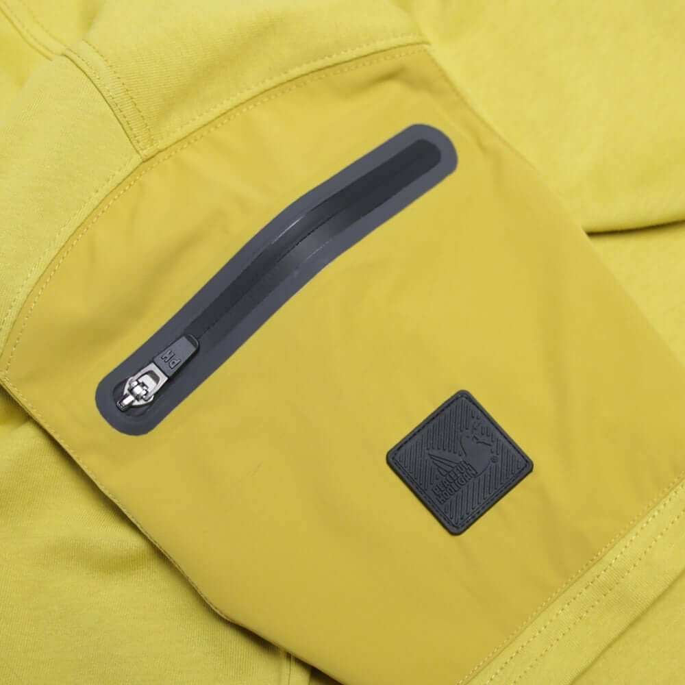 Detail of Peaceful Hooligan FORGE T Shirt Acid Mustard showing sleeve pocket and dove black badge for added style.