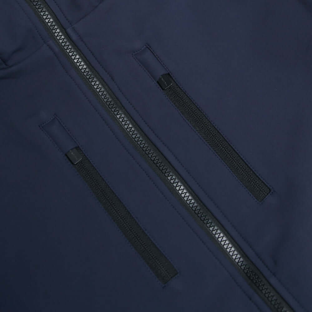 Close-up of navy softshell jacket zip pockets showcasing water-resistant design and premium fabric.