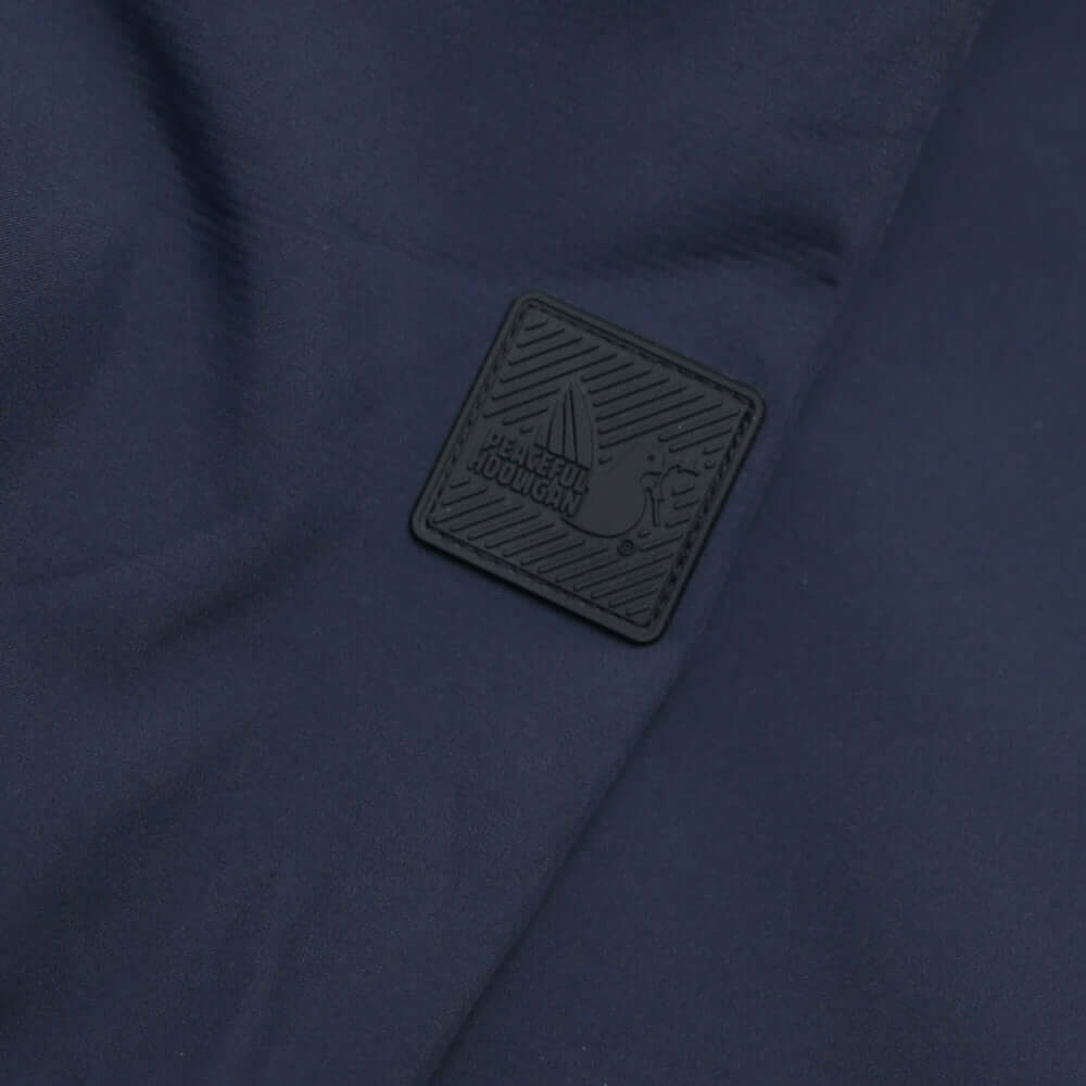 Close-up of the Dove Block badge on the Peaceful Hooligan MARKSMAN Softshell Jacket in Navy fabric.