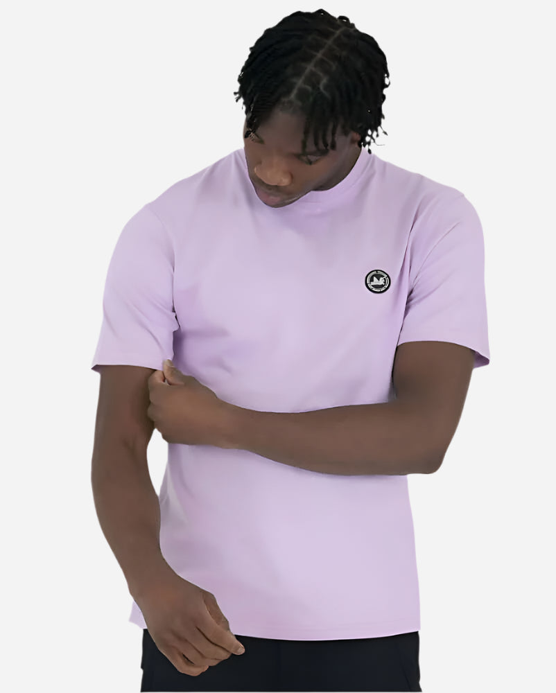 Model wearing Peaceful Hooligan Summer of Dove lavender T-shirt with logo on chest.