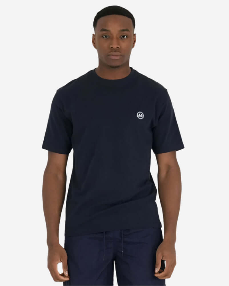 Model wearing the Peaceful Hooligan SUMMER OF DOVE T Shirt in navy with logo on chest.