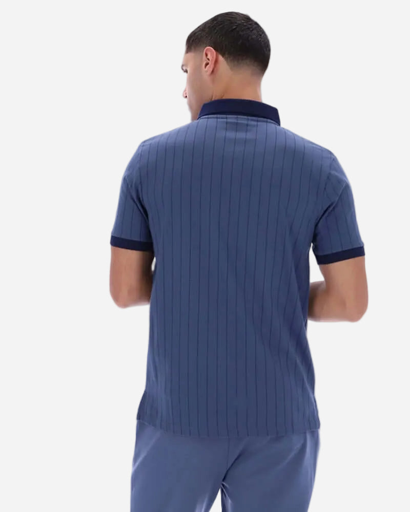 Back view of a man wearing Fila BB1 Polo Indigo, showcasing its vintage sportswear style and striped design.