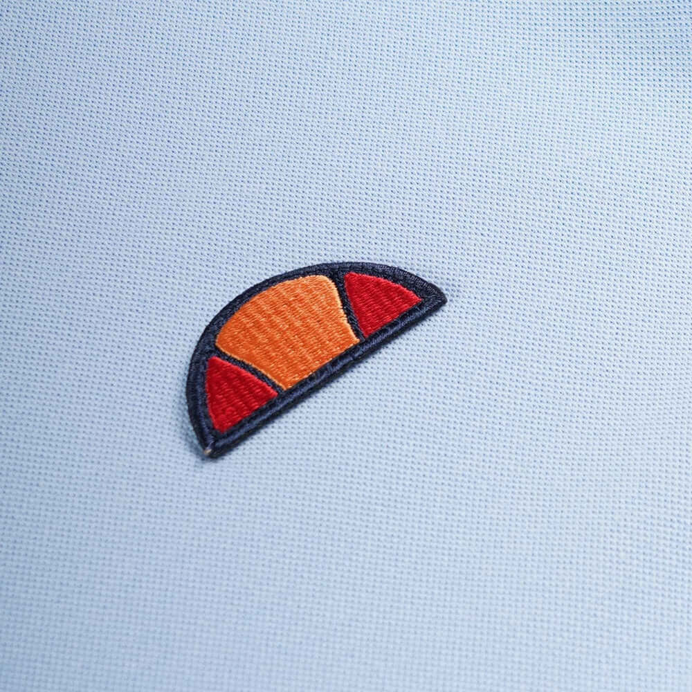 Ellesse logo embroidery detail on light blue fabric for BELVIDER T Shirt from Live Forever Collection.