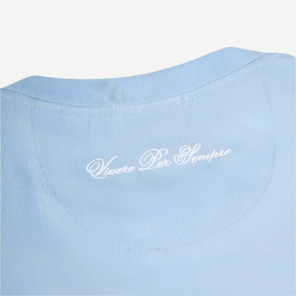 Detail of Ellesse DINELLI T Shirt Light Blue featuring 'Vivere Per Sempre' embroidered on the neckline.