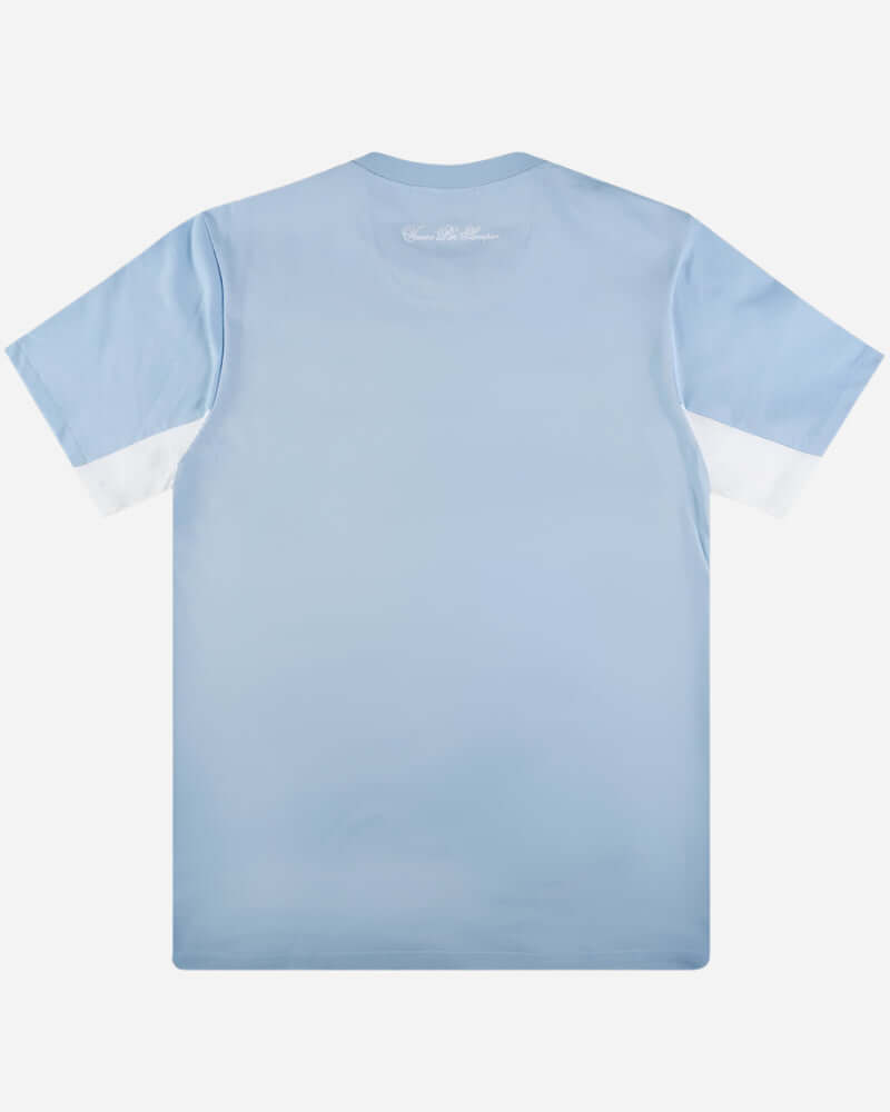 Ellesse DINELLI T Shirt in light blue, showcasing a classic crew neckline and block stripe detailing in the Live Forever Collection.