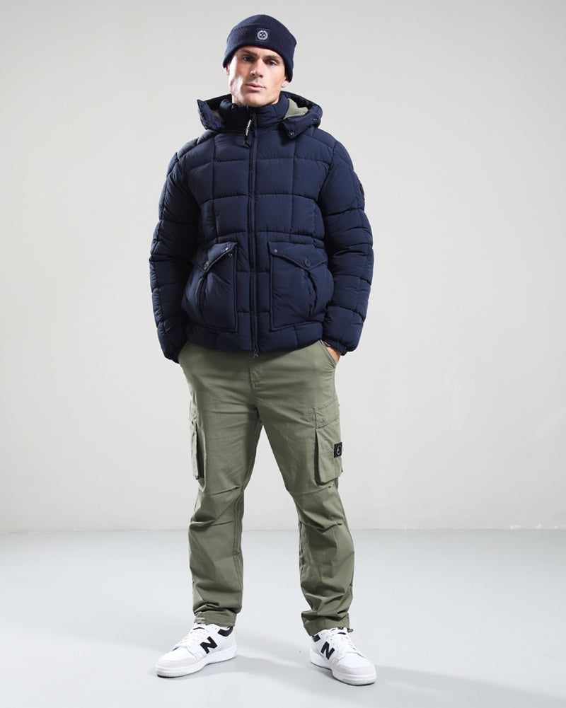 Model wearing Marshall Artist YUKON Bubble Jacket Navy paired with cargo pants and sneakers.