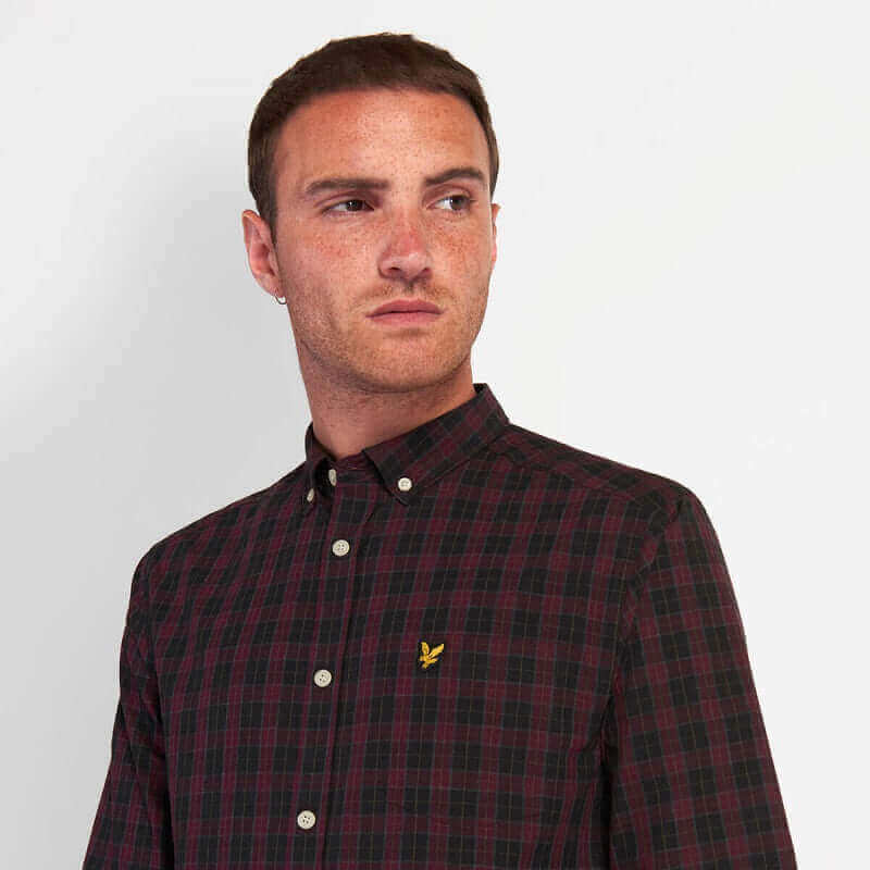 Lyle and Scott new autumn drops plaid shirt model wearing stylish outfit with a serious expression.
