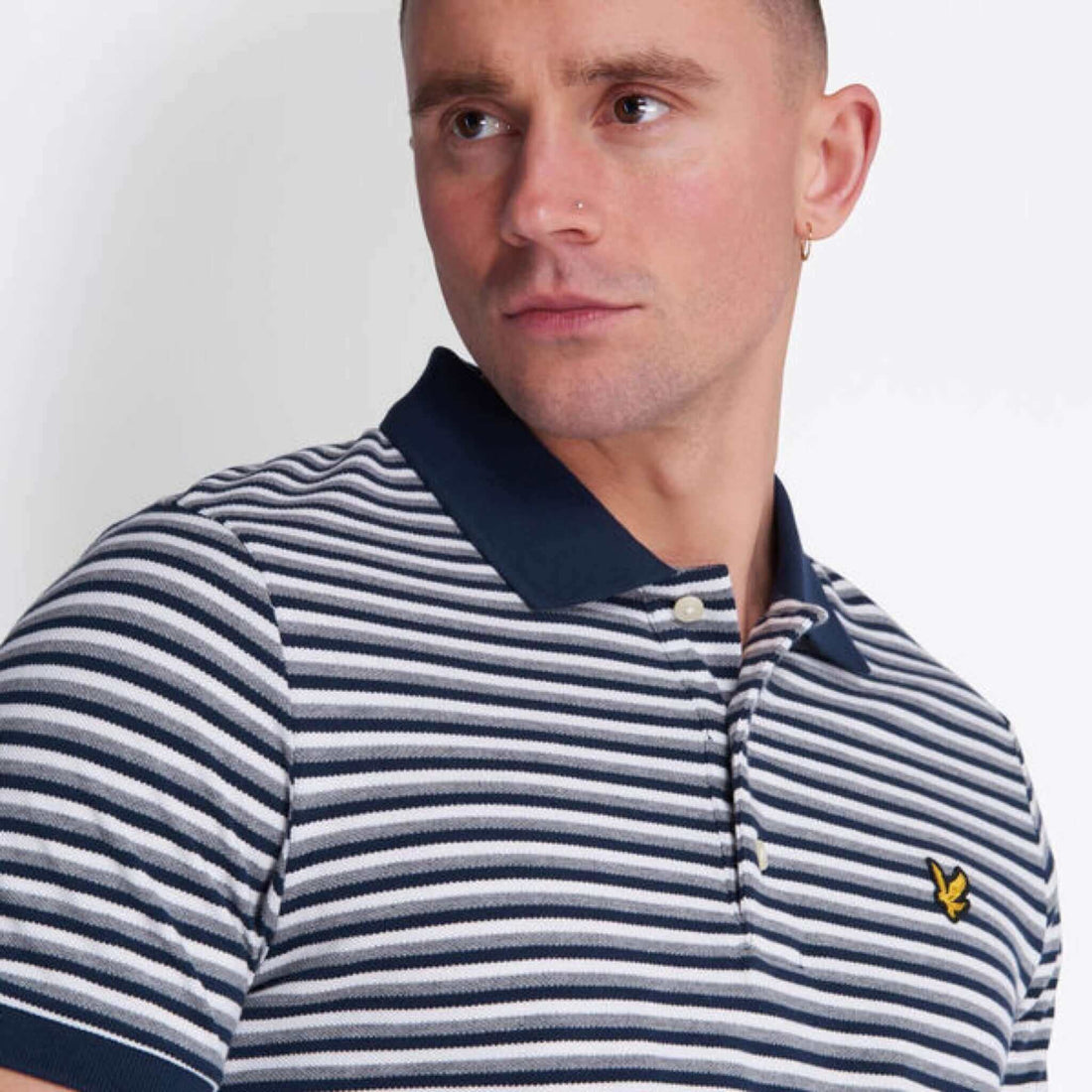 Model showcasing Lyle and Scott vintage striped polo shirt in spring summer 2020 collection.