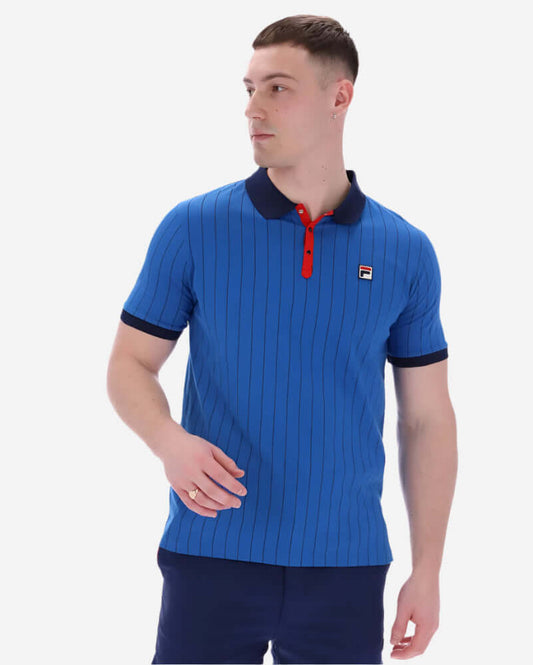 Fila BB1 Polo Turkish Sea/Navy/Red featuring iconic stripes and logo, model wearing it confidently.