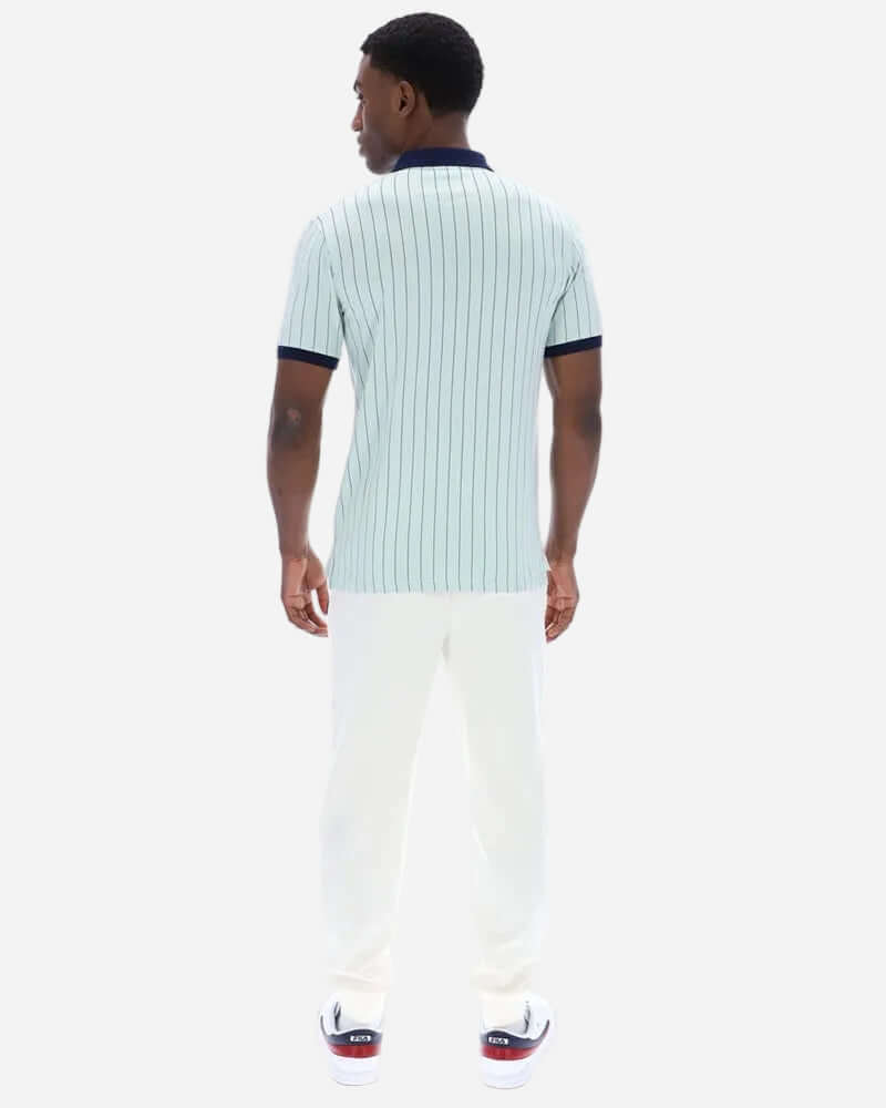 Back view of a man wearing the Fila BB1 Polo Surf Spray/Navy/White, showcasing its vintage striped design.