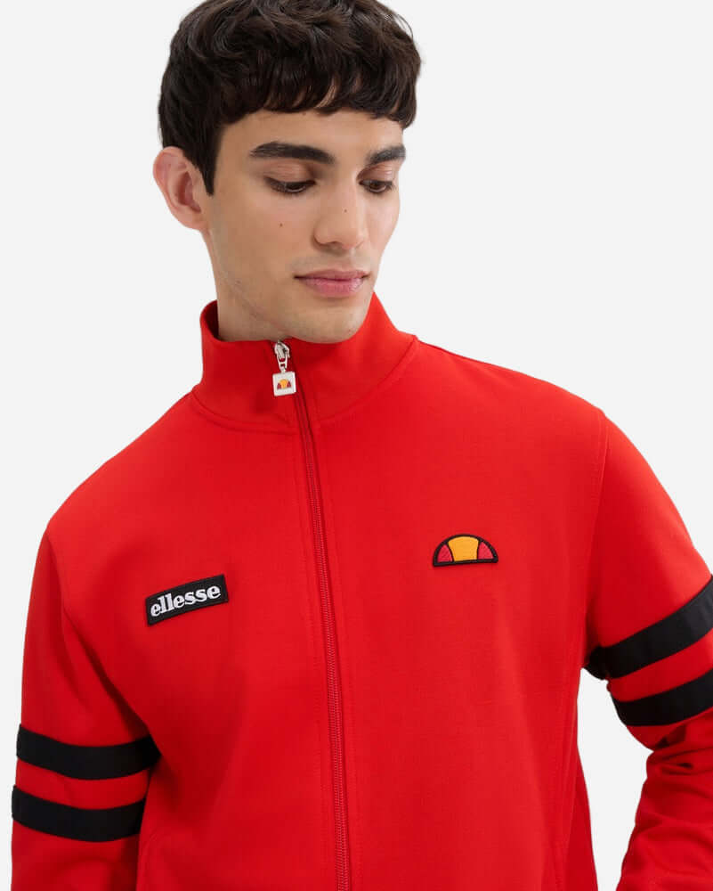Ellesse ROMA Track Jacket Red Black on model featuring logo and classic sleeve stripes.