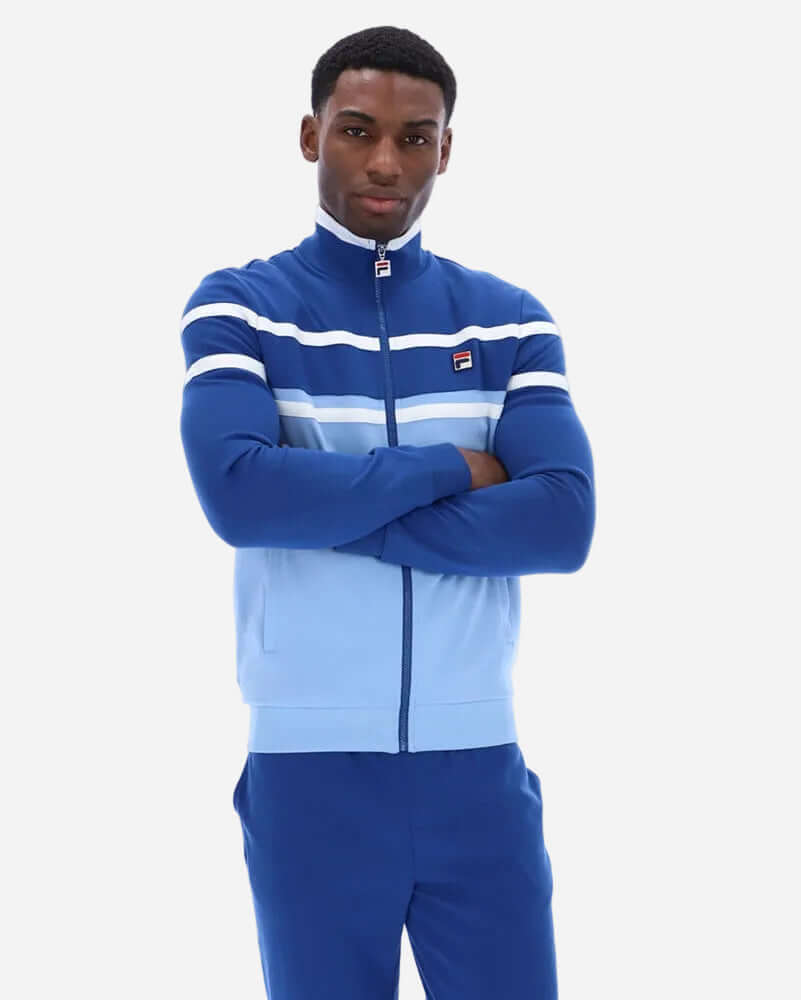 Fila GIOVANNI Track Jacket Frozen Fjord modeled by a man wearing a stylish full-zip track jacket in blue.