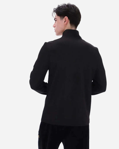 Back view of a model wearing the Fila Gold HOGAN Quarter Zip Top Black showcasing its sleek design and fit.