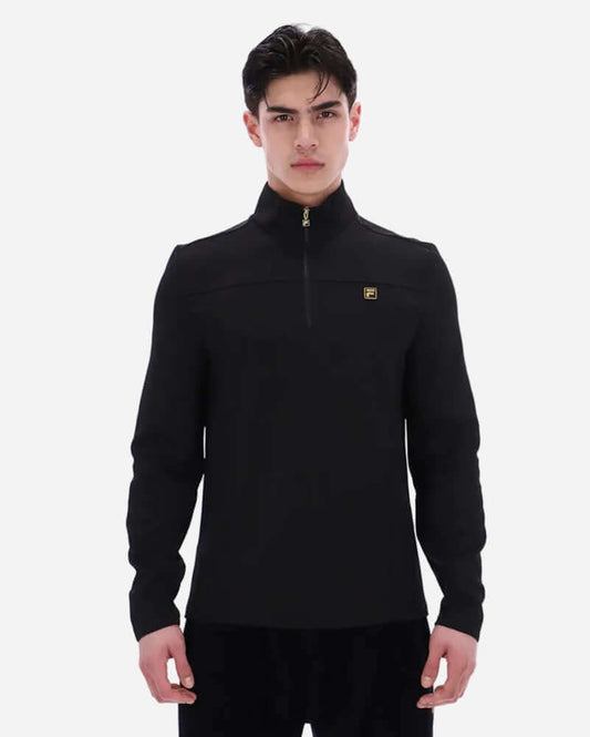 Fila Gold HOGAN Quarter Zip Top Black on a model, featuring a quarter zip design and ribbed cuffs for a modern look.