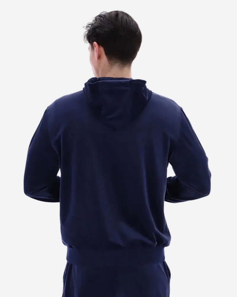 Back view of a man wearing the Fila Vintage ITALO Velour Hoodie Navy, showcasing its sleek design and hood.