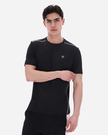 Fila LAWRENZE T Shirt Black worn by a model, featuring minimalist design and off-white piping details.