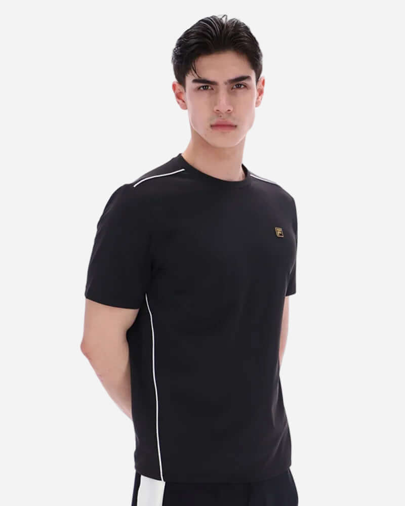 Fila LAWRENZE T Shirt Black worn by a male model, showcasing its minimalist design and contrast piping details.