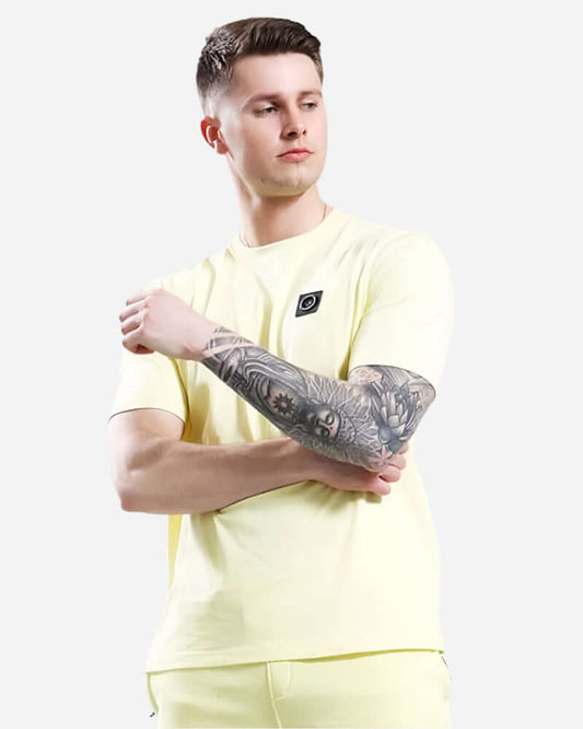 Model wearing Marshall Artist SIREN T Shirt in lemon with Micro Siren logo, showcasing a stylish and bold streetwear look.