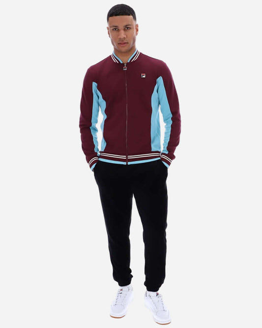 Model wearing Fila Settanta Track Top Fig/Milky Blue/Gardenia, showcasing retro design and sporty style.