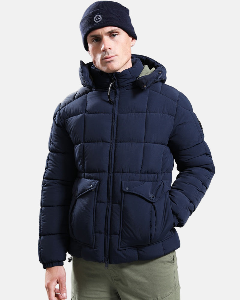 Marshall Artist YUKON Bubble Jacket Navy worn by a model, showcasing its square baffle construction and adjustable hood.