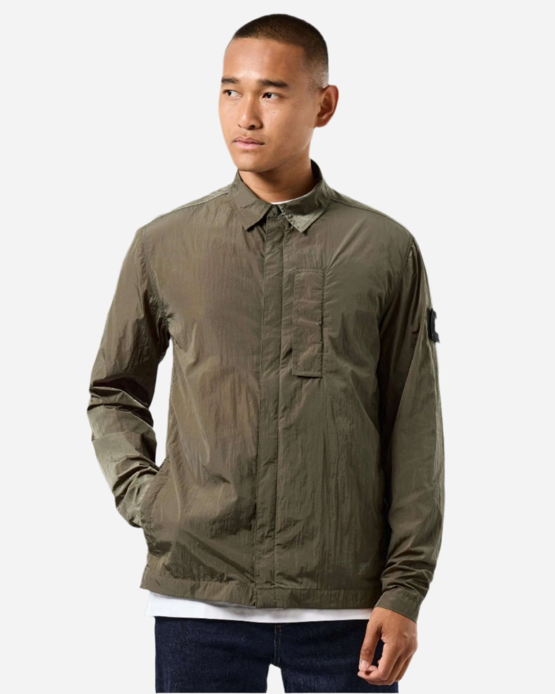 Man wearing Weekend Offender PORTER Overshirt Castle Green, lightweight nylon with storm placket, perfect for outdoor activities.