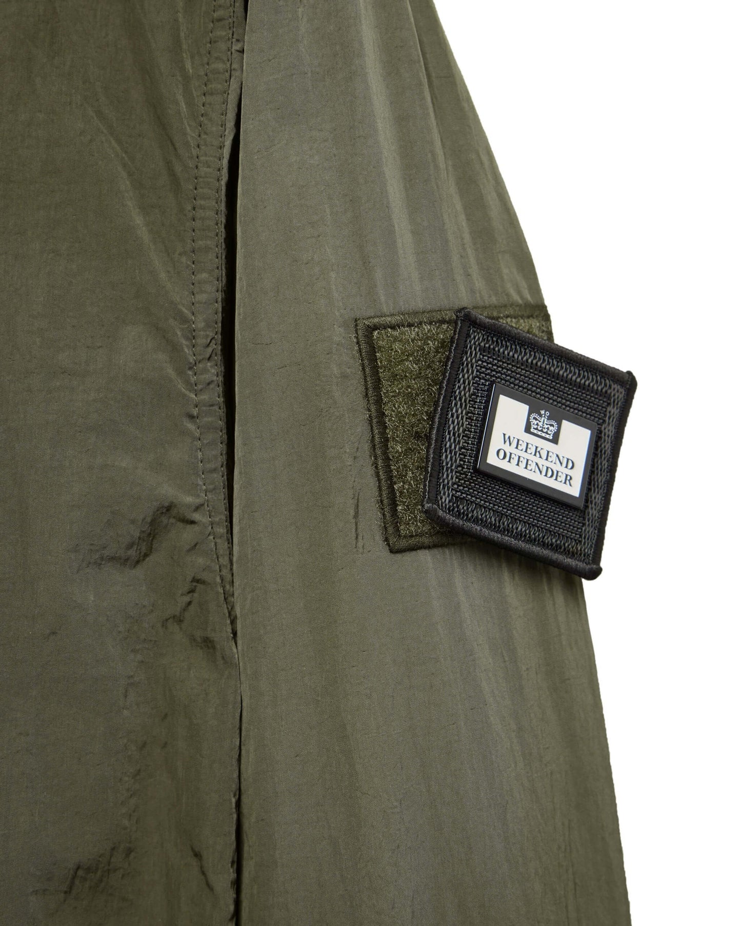 Close-up of Weekend Offender PORTER Overshirt in Castle Green showing branded patch on sleeve.