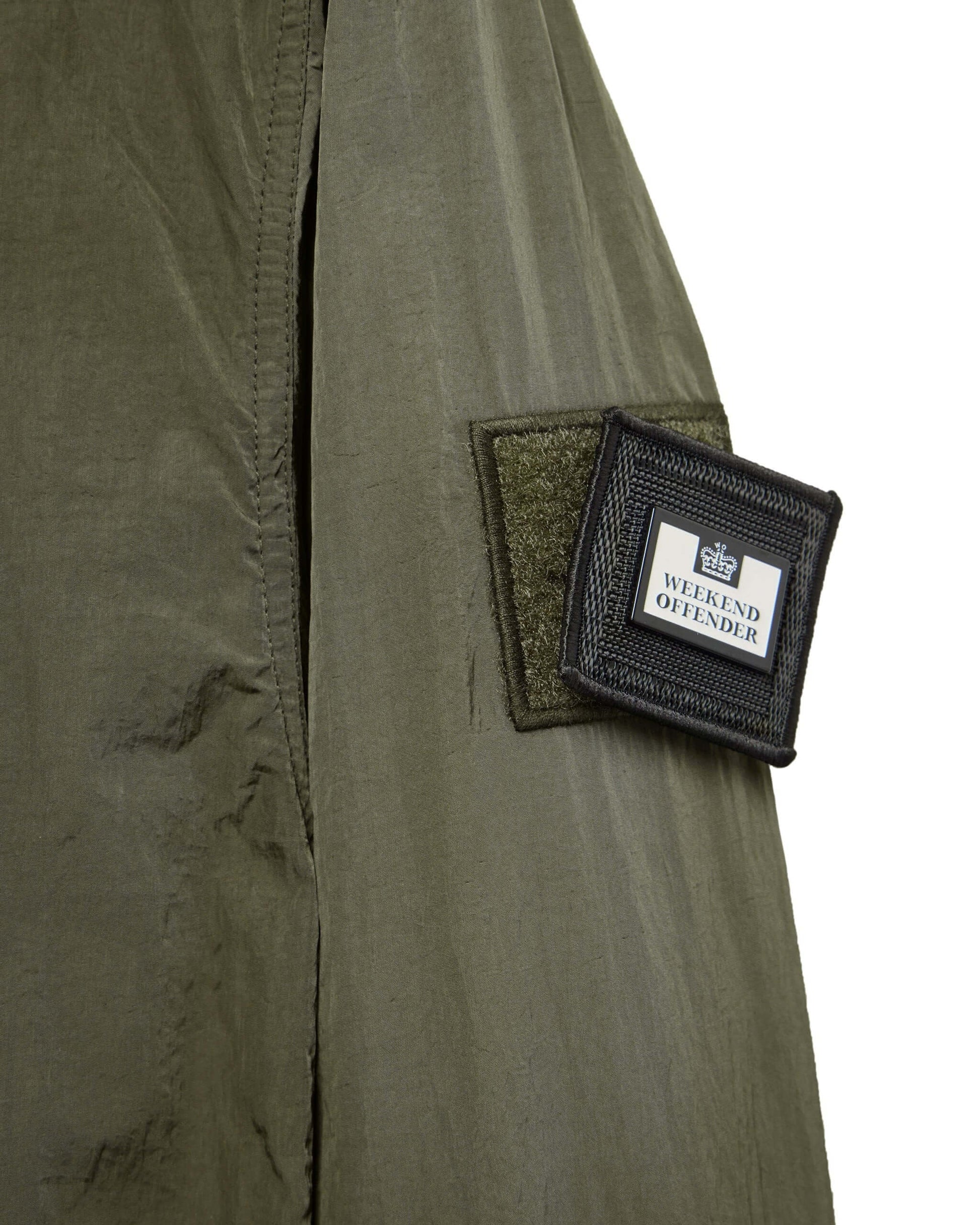 Close-up of Weekend Offender PORTER Overshirt in Castle Green showing branded patch on sleeve.